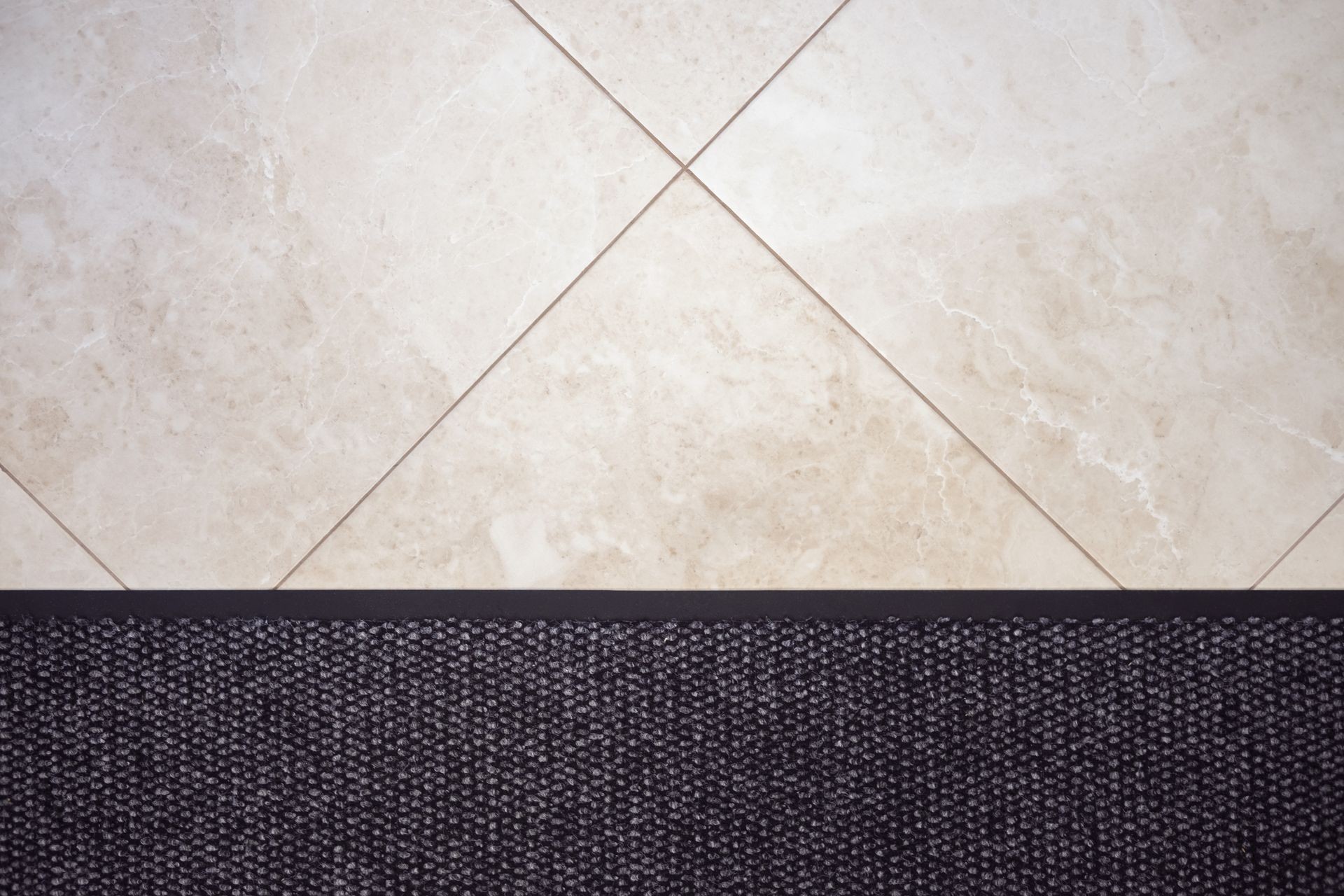 Floor carpet and beige  marble tile. Apartment interior design